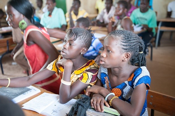 Young girls learning to read and write Young girls learning to read and write